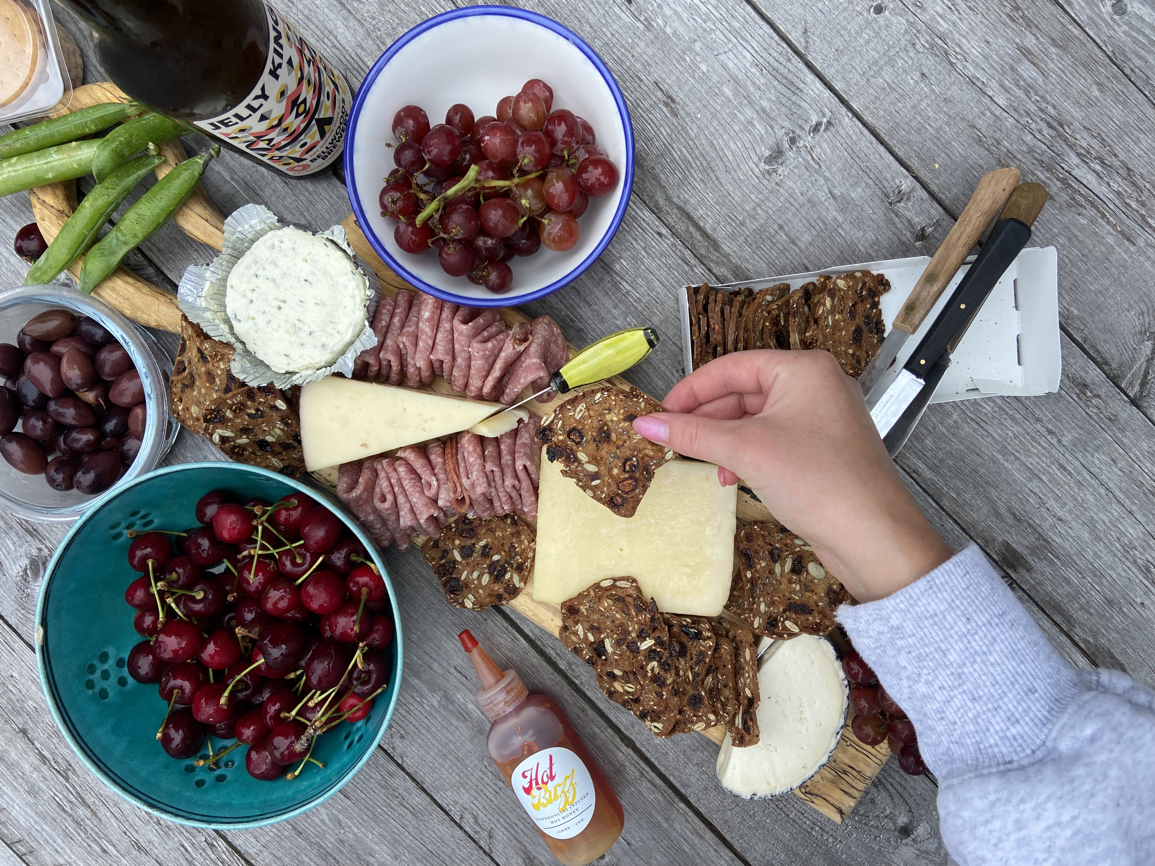 Charcuterie board served with Hot Buzz hot honey